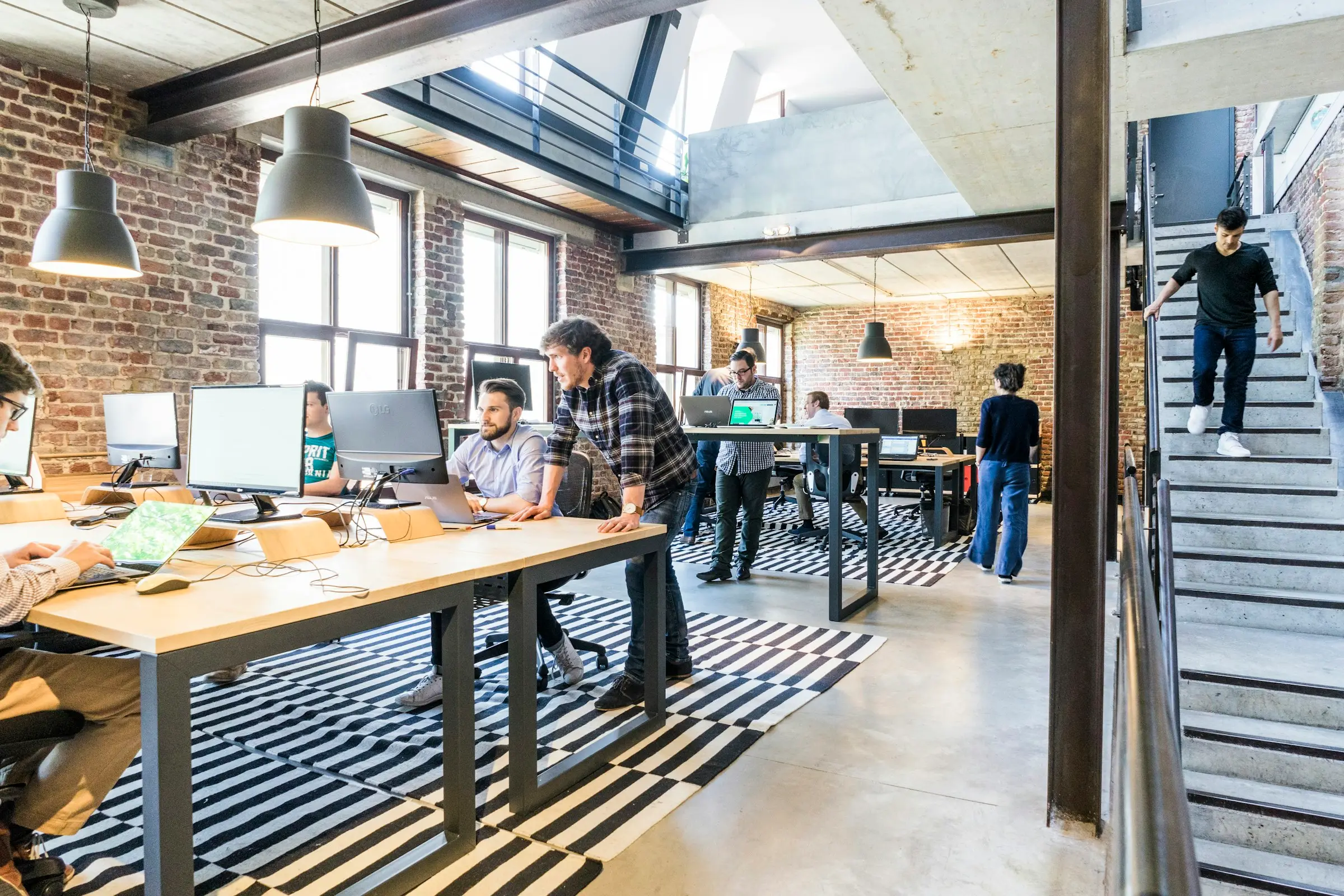 A small team at work in a brick-walled startup loft