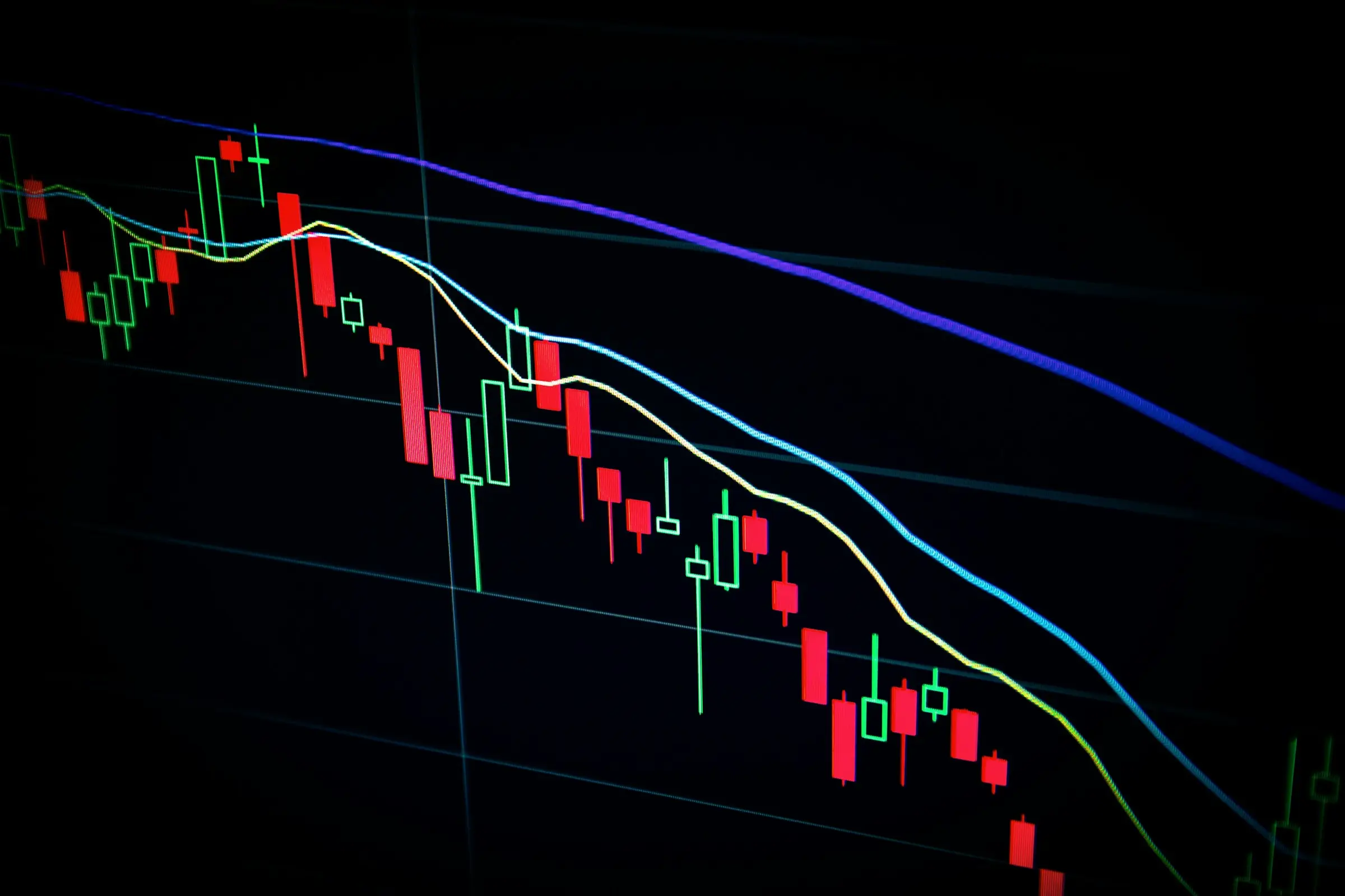 Candlestick charts glowing on a dark trading screen